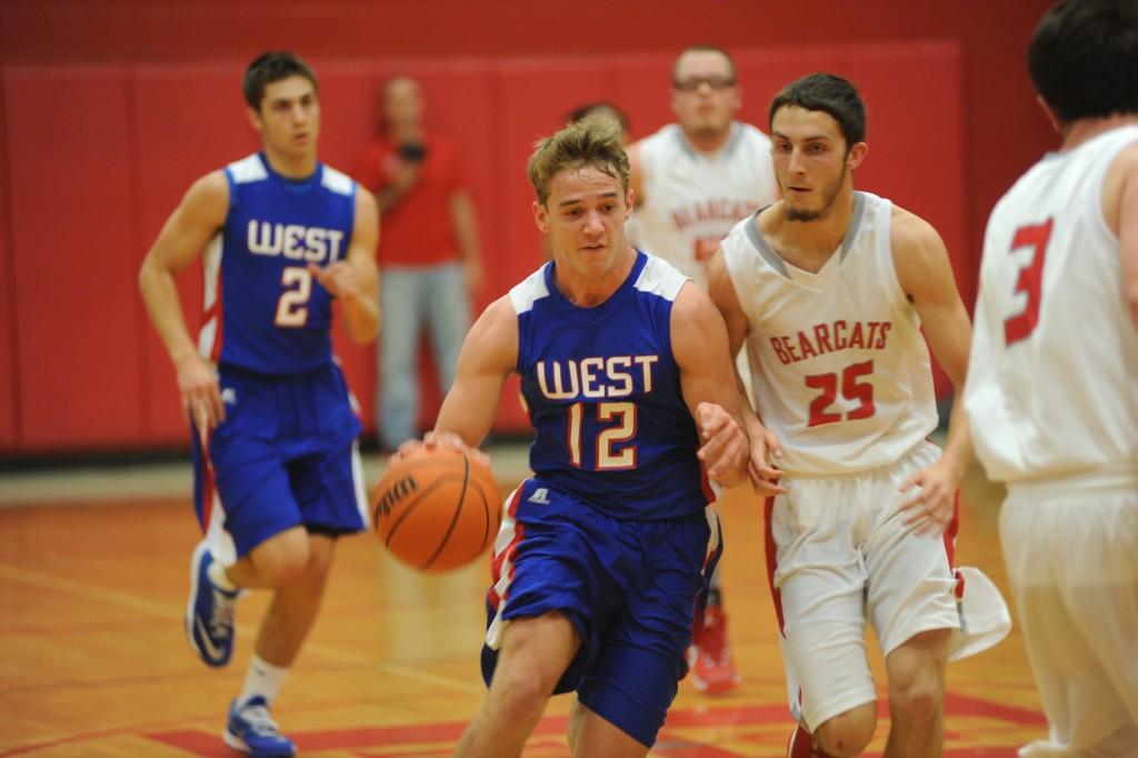 Junior Tristan Thomas dribbles past a defender in the game against Hendersonville. The Falcons defeated the  Bearcats 69-46. Photo by Lifetouch. 