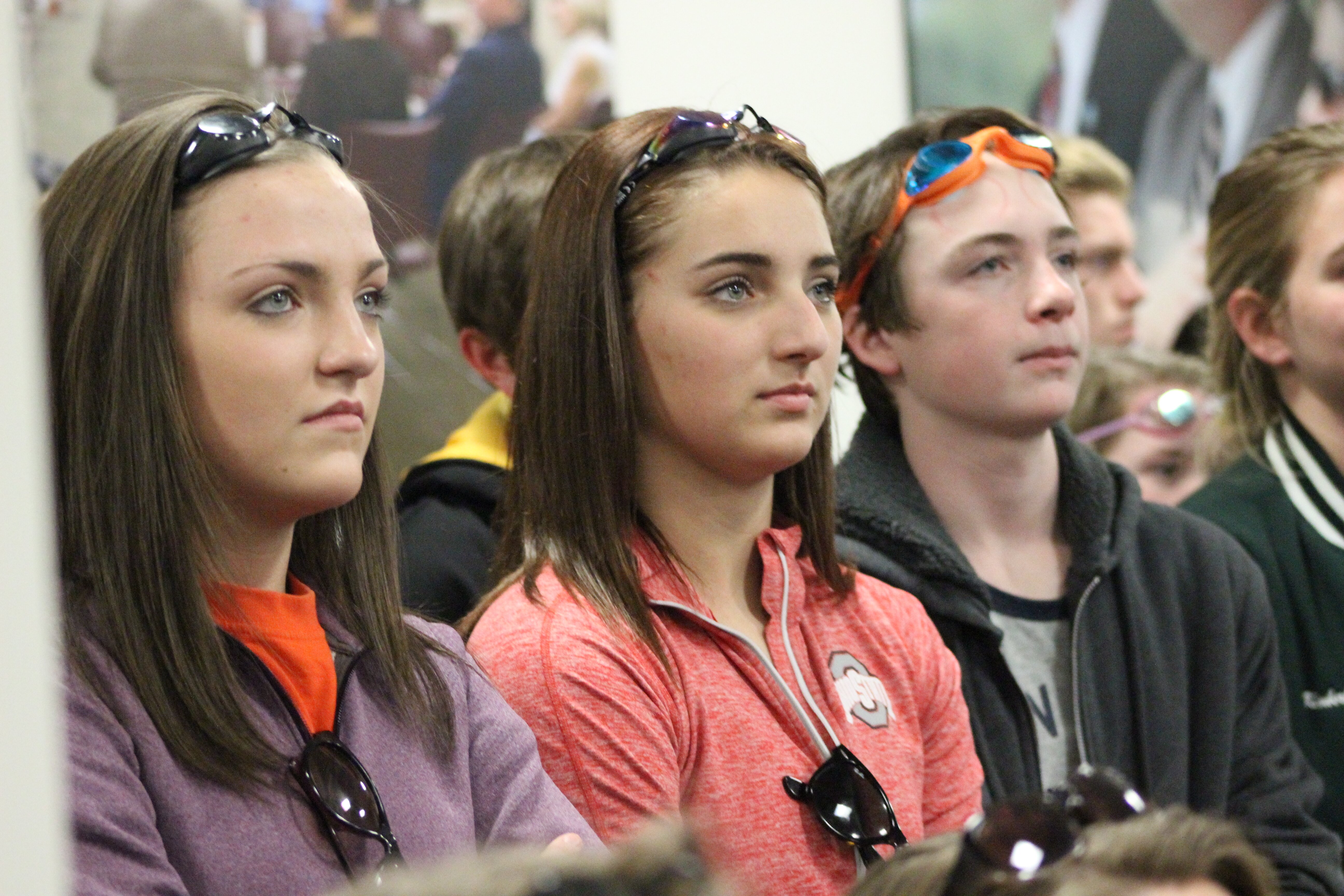 Swim team members Bailey Austin and Arielle Blake listen closely to speakers at the Buncombe County Commissioners meeting. Blake and Austin wore goggles in solidarity with the cause to keep Zeugner open. Photos by Ari Sen and Emily Treadway