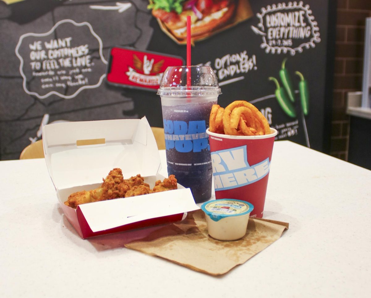 A blue and purple slushy sits elegantly on a table, with a cup of fries and a box of chicken wings. Sheetz is known for their convenient drive-thru and accompanying restaurant, providing 24/7 snacking.
(Photo by Nash Gates)